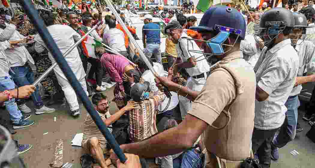BJP members and security personnel clash during a protest organised to mark the completion of one year of the rape and murder of a trainee doctor at RG Kar hospital.