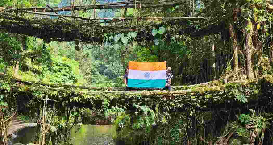 A couple displays the Indian tricolour on a Living Root Bridge in Meghalaya.