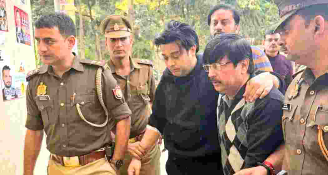 Shivam Mishra being escorted to a police station in Kanpur.