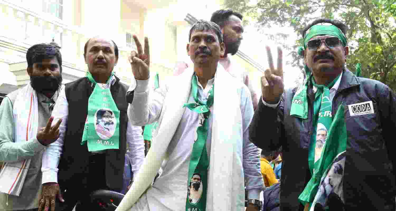 JMM candidate Somesh Soren shows victory sign with his supporters in Jamshedpur on Friday.