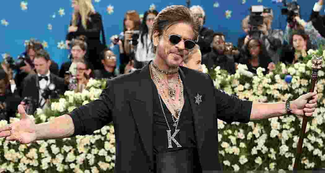 Shah Rukh Khan strikes his signature arms-stretched pose during his debut appearance at the Met Gala 2025 in New York