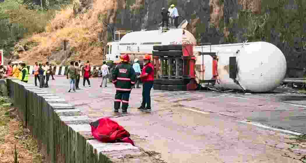  Firefighters and emergency responders attend to an overturned tanker on the Pune-Mumbai Expressway. Image: ANI