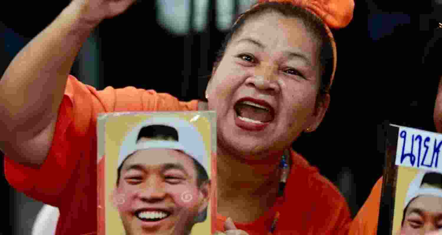 A People’s Party supporter, holding an image of the party leader, rallies at party headquarters during last week’s general election in Thailand.