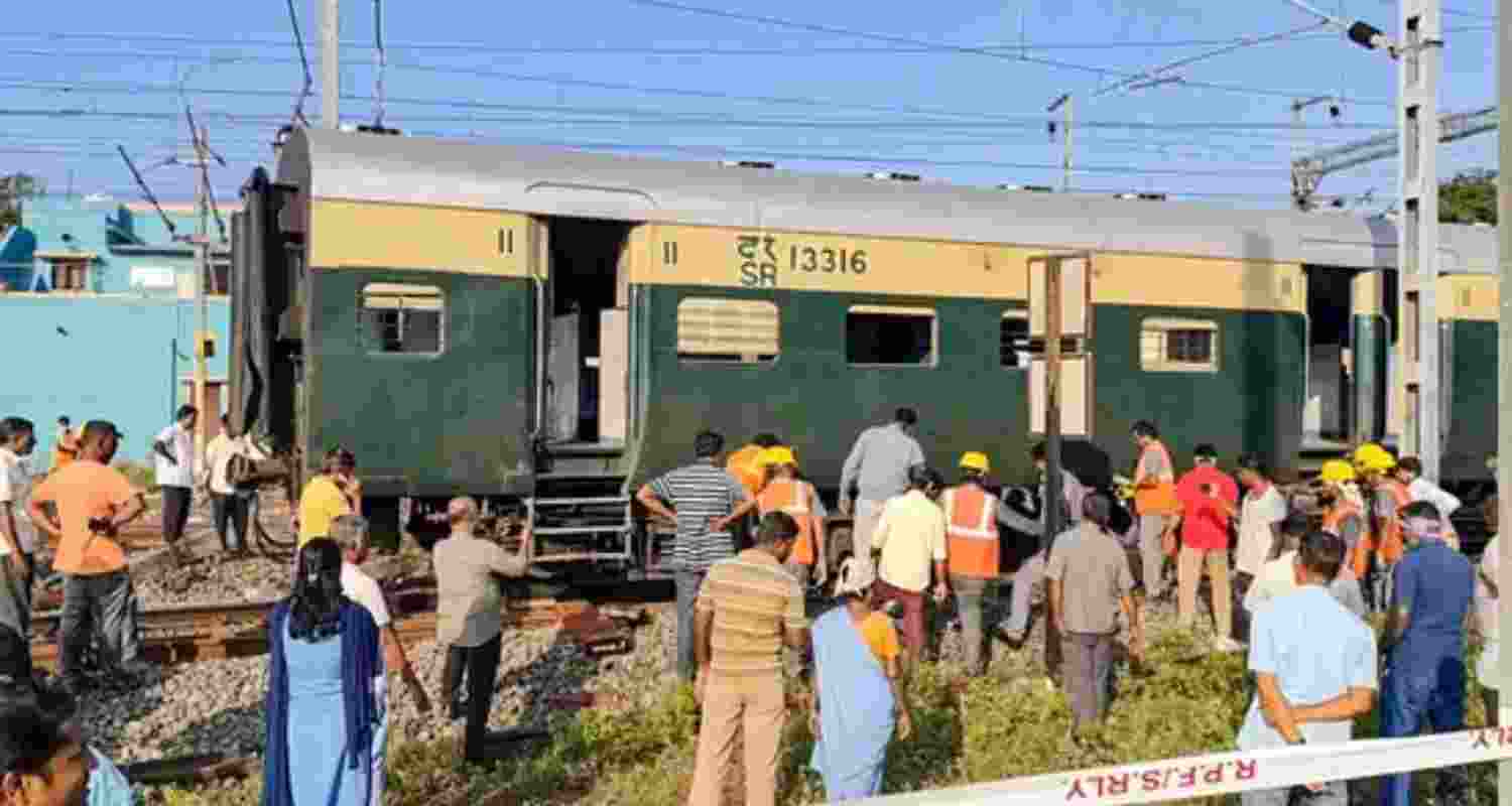 People gather at the site after a passenger train derailed near Tamil Nadu's Villupuram Railway Station.