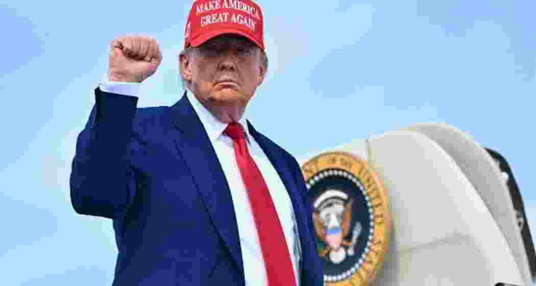 President Donald Trump raises his fist as he boards Air Force One before departing Morristown Municipal Airport in Morristown, New Jersey on June 21, 2025.