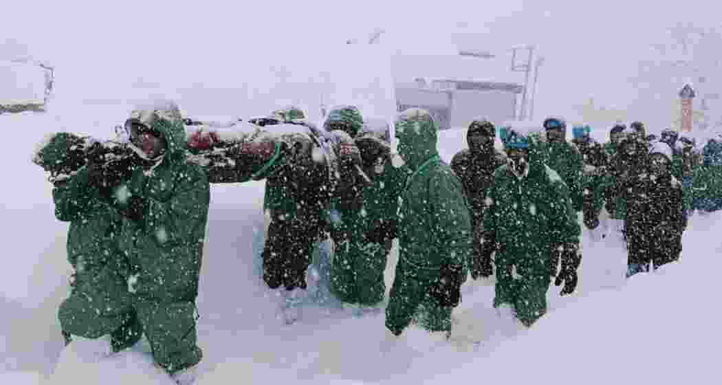 Army personnel rescue a trapped individual from the avalanche site in Uttarakhand's Chamoli district as efforts continue to locate missing workers amid challenging weather conditions.







