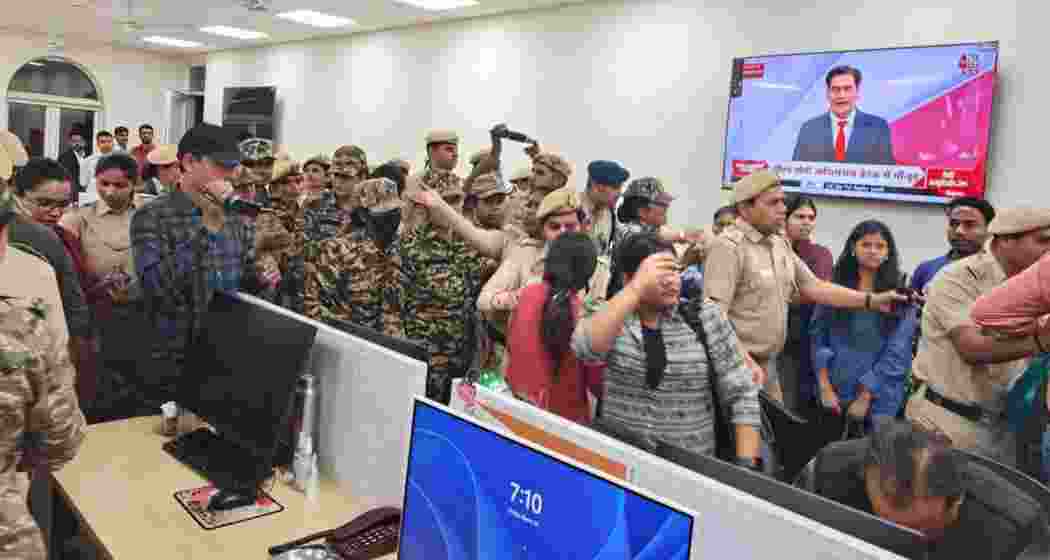 Delhi Police and CRPF personnel inside the UNI office on Friday. 