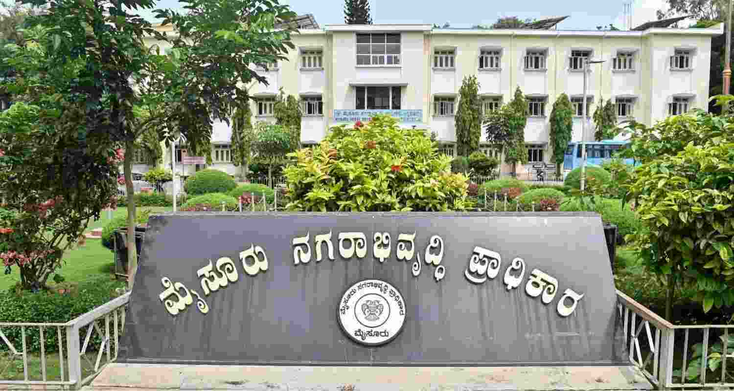 P S Kantharaju faces inquiry over controversial land deals.