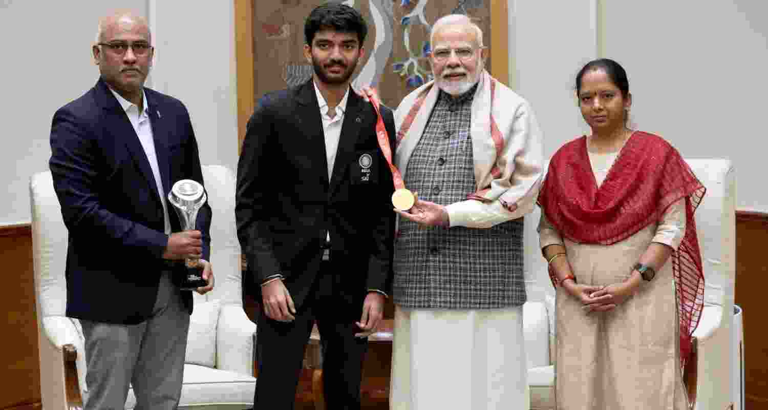 Gukesh D presents PM Modi with his winning chessboard.
