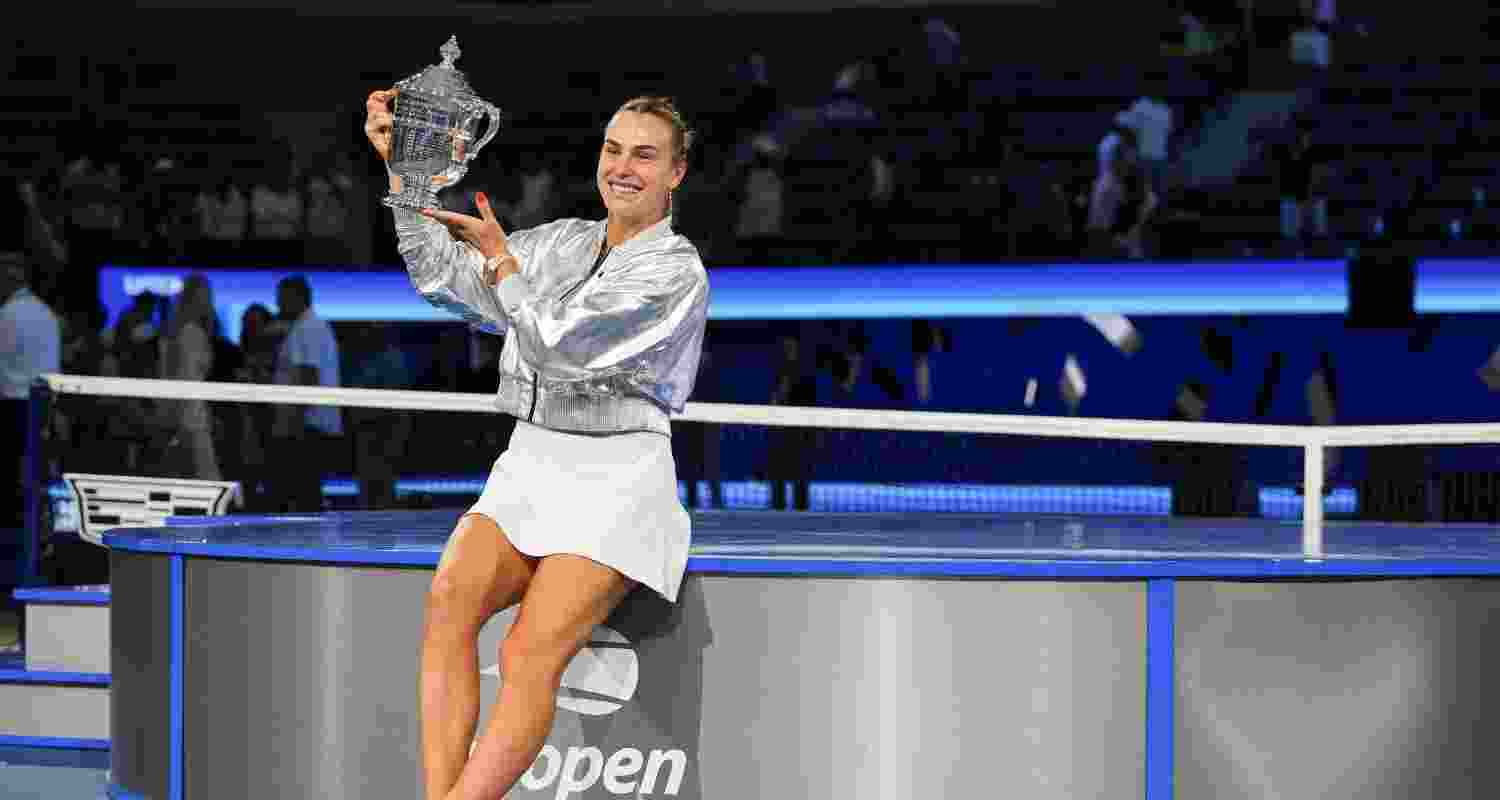 Aryna Sabalenka, of Belarus, holds up the championship trophy after defeating Amanda Anisimova, of the United States, in the women's singles final of the U.S. Open tennis championships, Saturday.