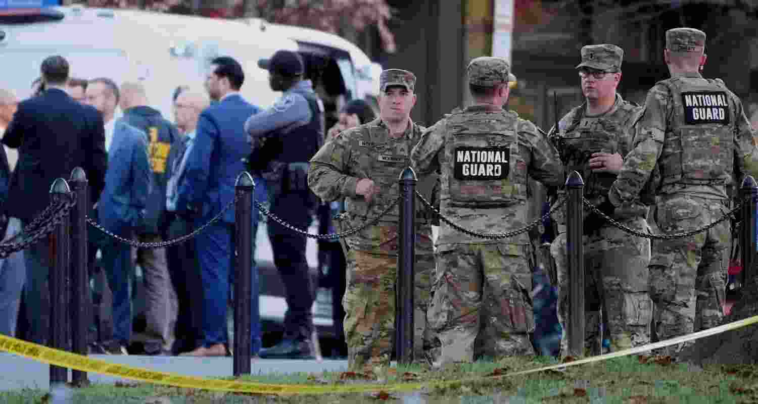 Emergency personnel gather in a cordoned off area where National Guard soldiers were shot near the White House Wednesday.