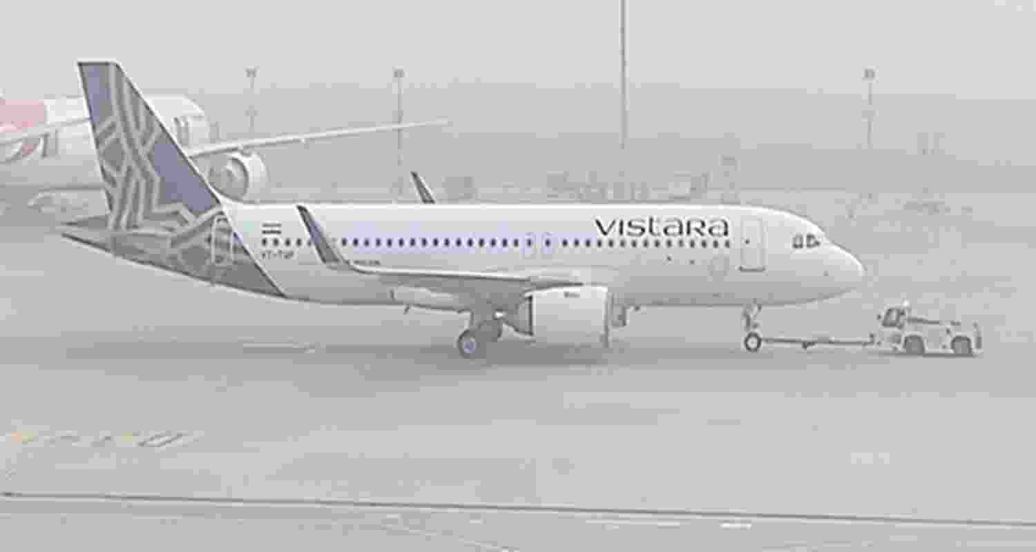 An aircraft waits to take off at the runway as dense smog reduce visibility and engulfs IGI airport. 