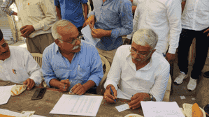 Union Minister Gajendra Singh Shekhawat makes voters' slips after casting vote in Jodhpur Union Minister Gajendra Singh Shekhawat makes voters' slips after casting vote in Jodhpur