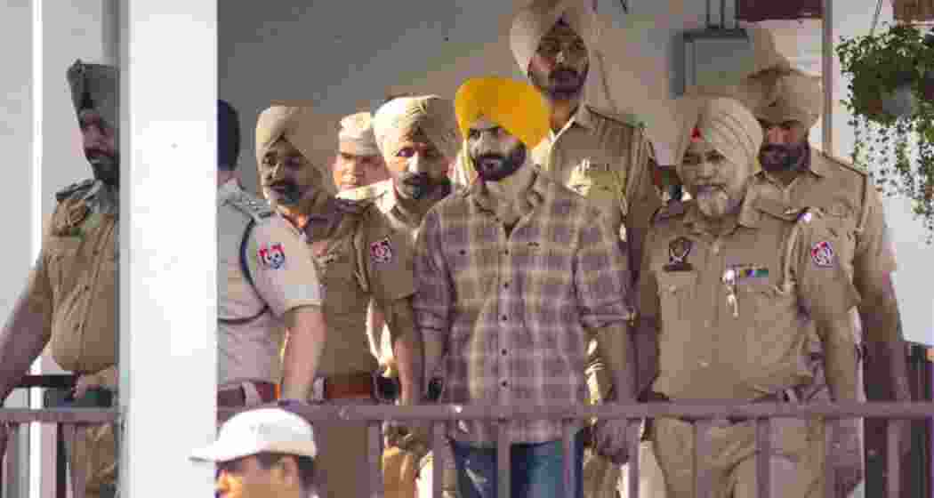 Daljit Singh Kalsi, an aide of Waris Punjab De chief Amritpal Singh, being escorted under heavy security after being remanded to police custody in Punjab. Daljit Singh Kalsi, an aide of Waris Punjab De chief Amritpal Singh, being escorted under heavy security after being remanded to police custody in Punjab.
