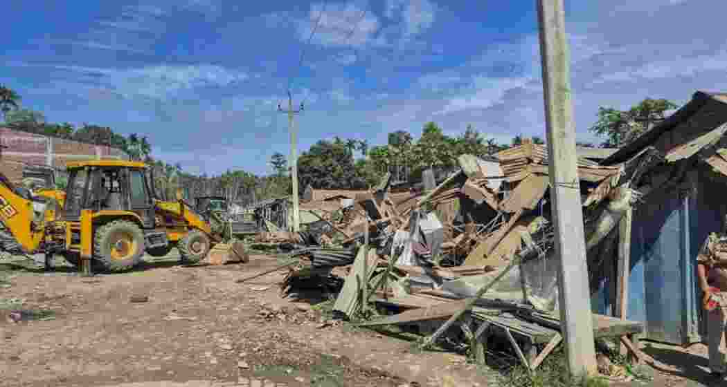 An excavator being used to demolish encroachments from the forest land, in Golaghat district, Assam. An excavator being used to demolish encroachments from the forest land, in Golaghat district, Assam.