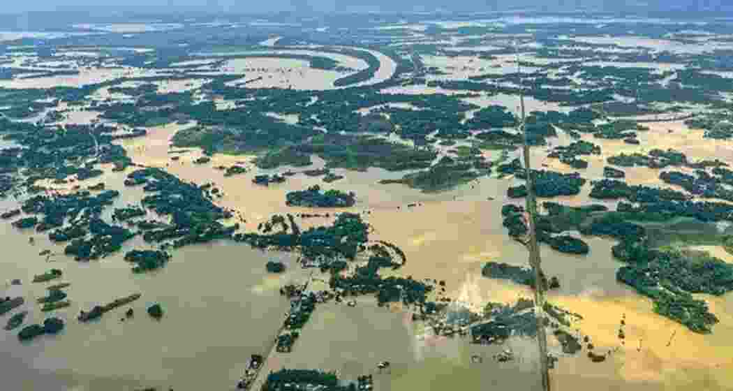Aerial view of flood-affected areas in Assam following heavy rainfall, showcasing the extent of the devastation. Aerial view of flood-affected areas in Assam following heavy rainfall, showcasing the extent of the devastation.