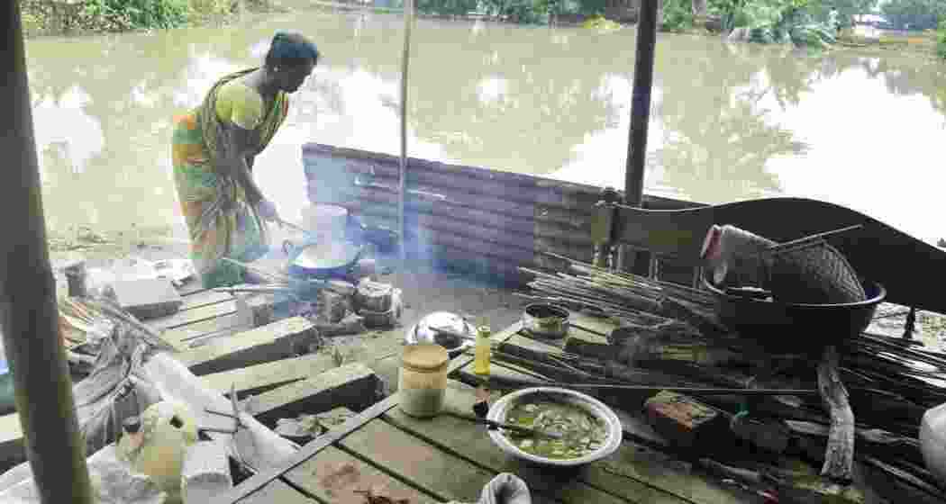 A woman cooks food at a flood affected village, in Morigaon district of Assam, Thursday, July 4, 2024. A woman cooks food at a flood affected village, in Morigaon district of Assam, Thursday, July 4, 2024.