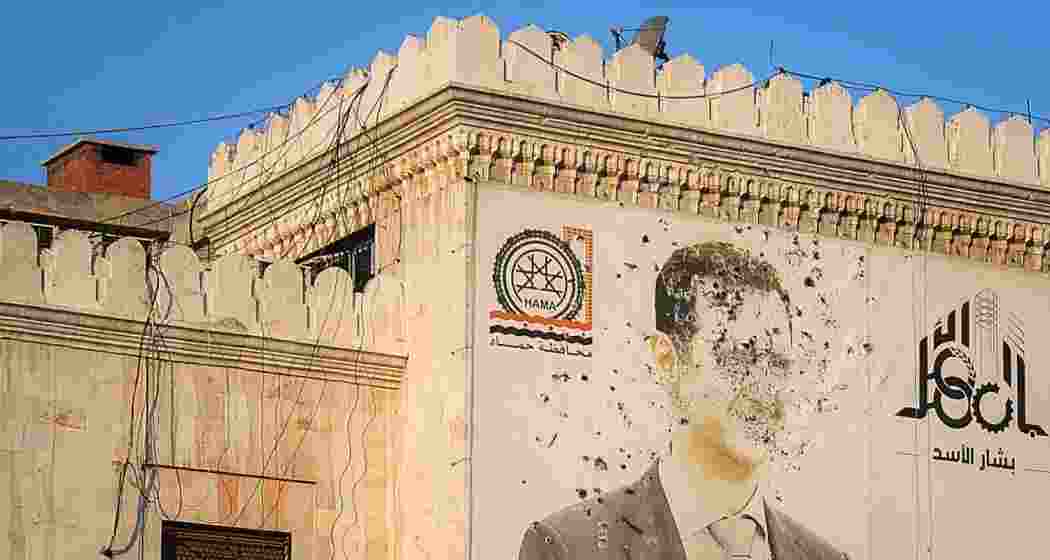 An image of Syrian President Bashar al-Assad, riddled with bullets, is displayed on the facade of the provincial government office following the opposition's capture of Hama. An image of Syrian President Bashar al-Assad, riddled with bullets, is displayed on the facade of the provincial government office following the opposition's capture of Hama.