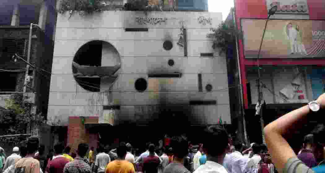 Dhaka: People gather in front of the ransacked Awami League's central office in the aftermath of the prime minister's resignation, in Dhaka, Bangladesh, 06 August 2024. Dhaka: People gather in front of the ransacked Awami League's central office in the aftermath of the prime minister's resignation, in Dhaka, Bangladesh, 06 August 2024.