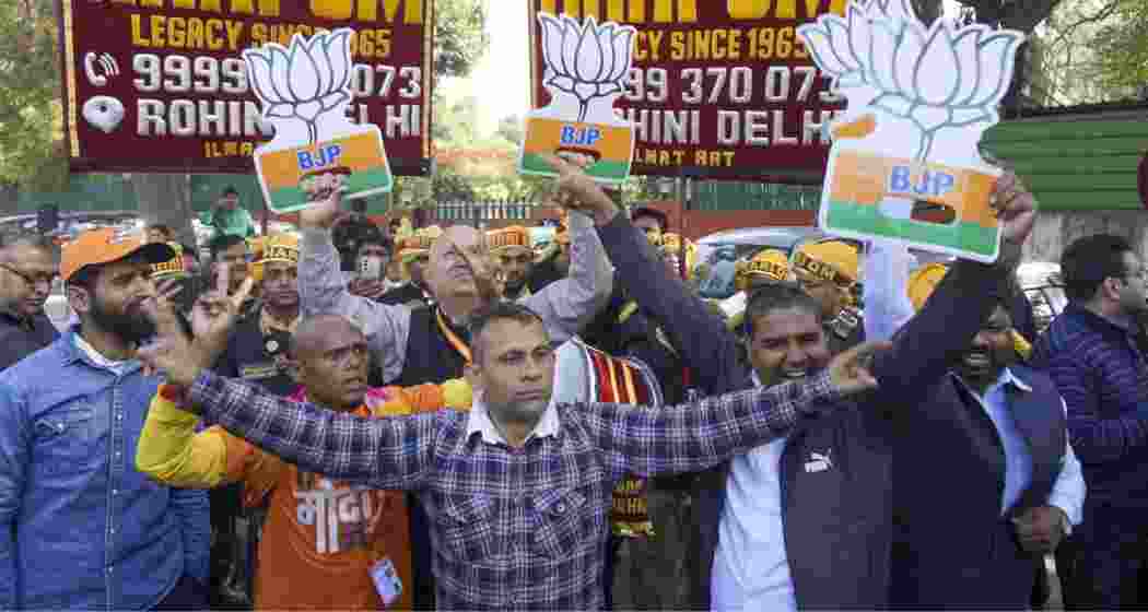 BJP supporters celebrate the party's lead in Delhi Assembly polls during counting of votes, in New Delhi on Saturday, Feb. 8, 2025. BJP supporters celebrate the party's lead in Delhi Assembly polls during counting of votes, in New Delhi on Saturday, Feb. 8, 2025.