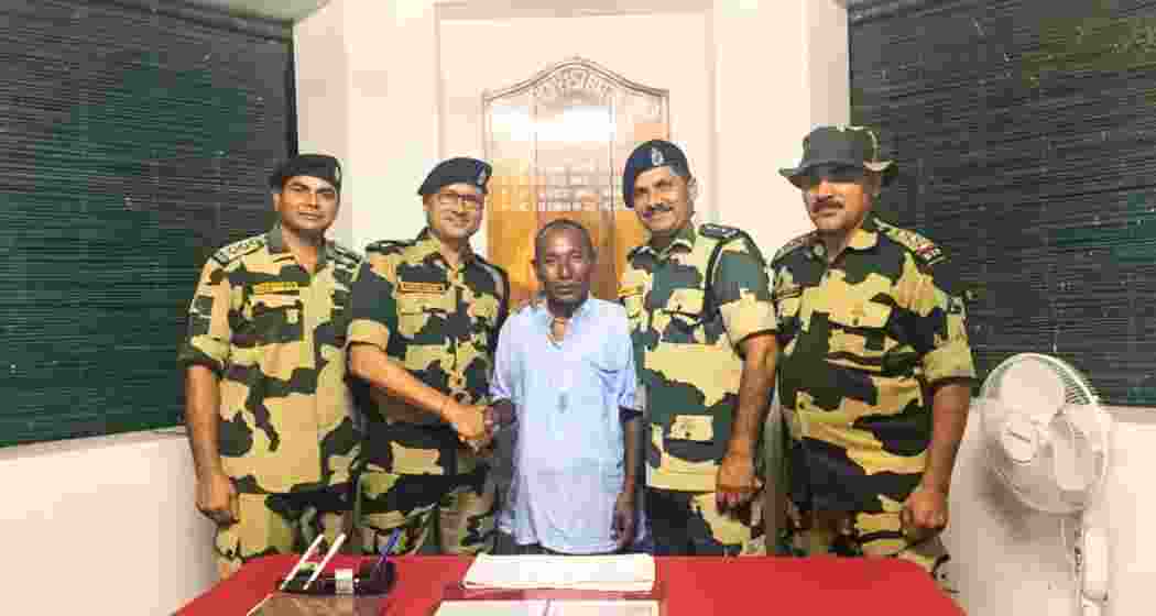 Chandrakant Barman, a North Bengal farmer, with BSF officials, including North Bengal Inspector General Rajesh Kumar Yadav, at Shitalkuchi police station in Cooch Behar, after his return from Bangladesh. Chandrakant Barman, a North Bengal farmer, with BSF officials, including North Bengal Inspector General Rajesh Kumar Yadav, at Shitalkuchi police station in Cooch Behar, after his return from Bangladesh.