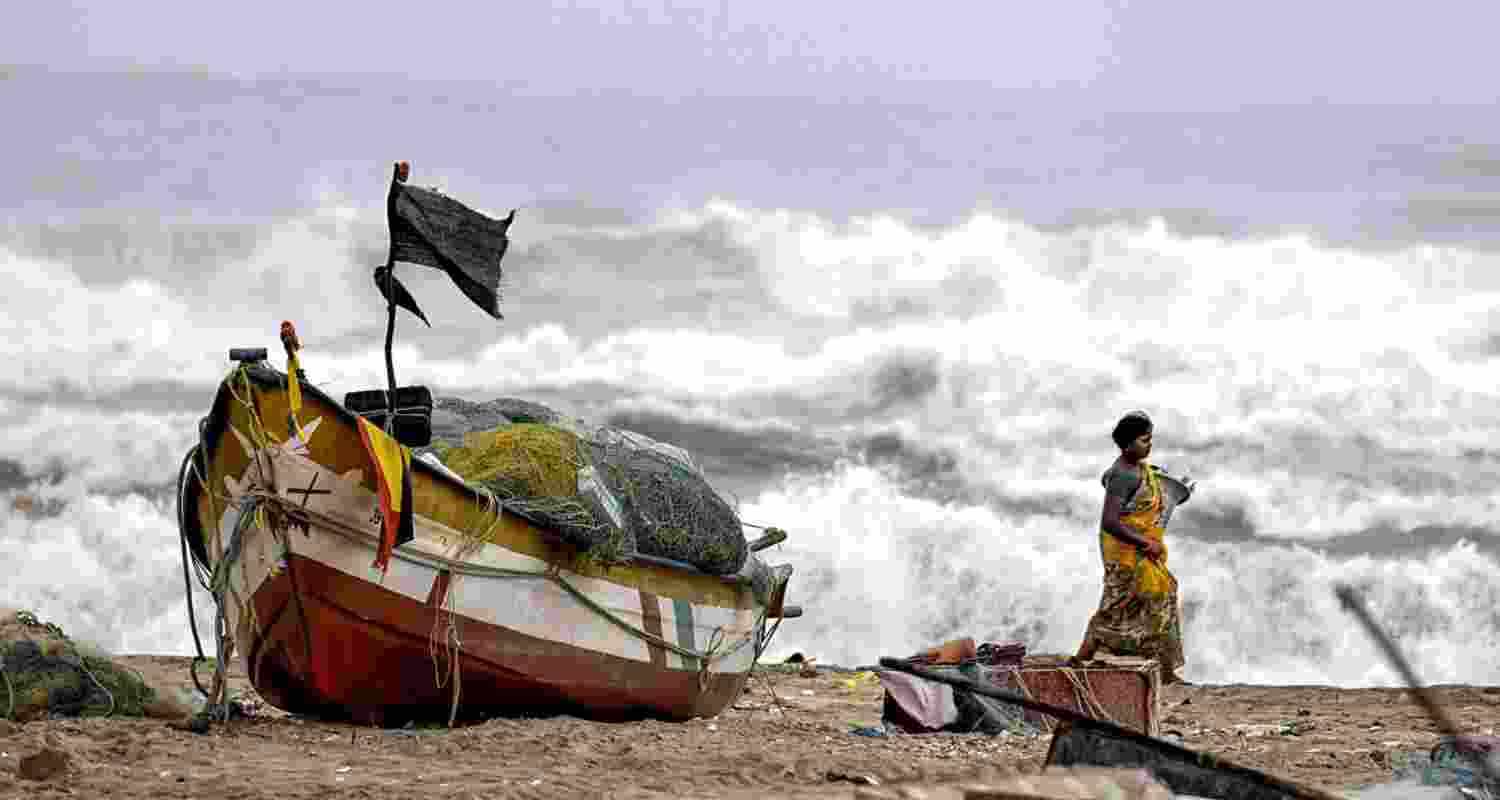 A fisherwoman in the coastal region of India during cyclone Michaung caused by climate change A fisherwoman in the coastal region of India during cyclone Michaung caused by climate change