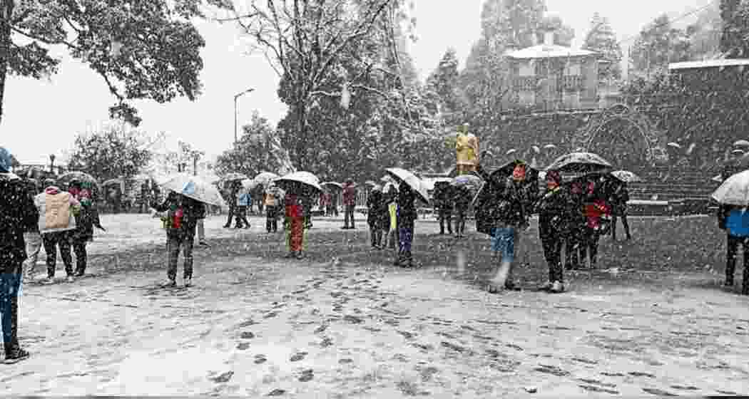 People are enjoying the snowfall at Darjeeling's Mall Road. People are enjoying the snowfall at Darjeeling's Mall Road.