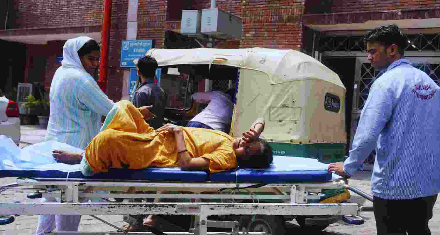 A woman suffering from a heat-related illness being brought to LNJP Hospital for treatment, as the national capital witnesses hot weather conditions, in New Delhi, Thursday, June 20, 2024. A woman suffering from a heat-related illness being brought to LNJP Hospital for treatment, as the national capital witnesses hot weather conditions, in New Delhi, Thursday, June 20, 2024.
