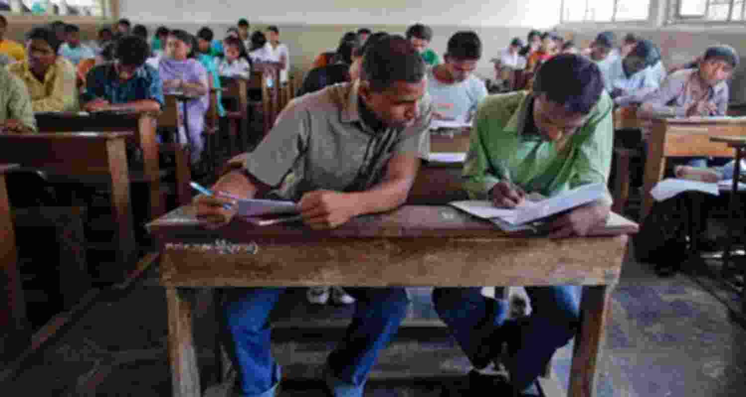 Students cheating in an exam. Students cheating in an exam.