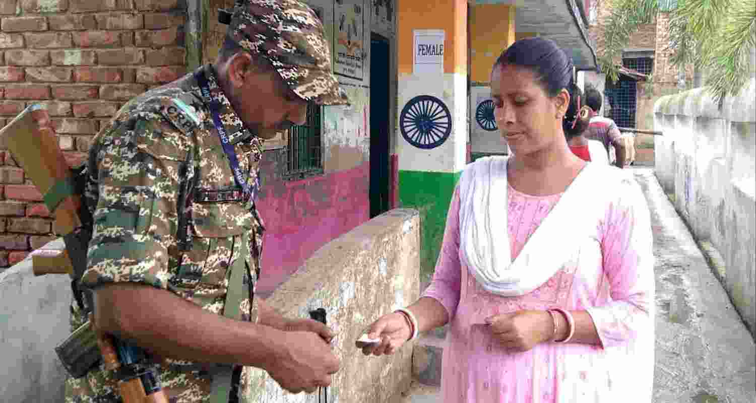A security official checks credentials of a voter at a polling station during the re-election to the Falta assembly seat, in South 24 Parganas district, West Bengal, Thursday, May 21, 2026. A security official checks credentials of a voter at a polling station during the re-election to the Falta assembly seat, in South 24 Parganas district, West Bengal, Thursday, May 21, 2026.