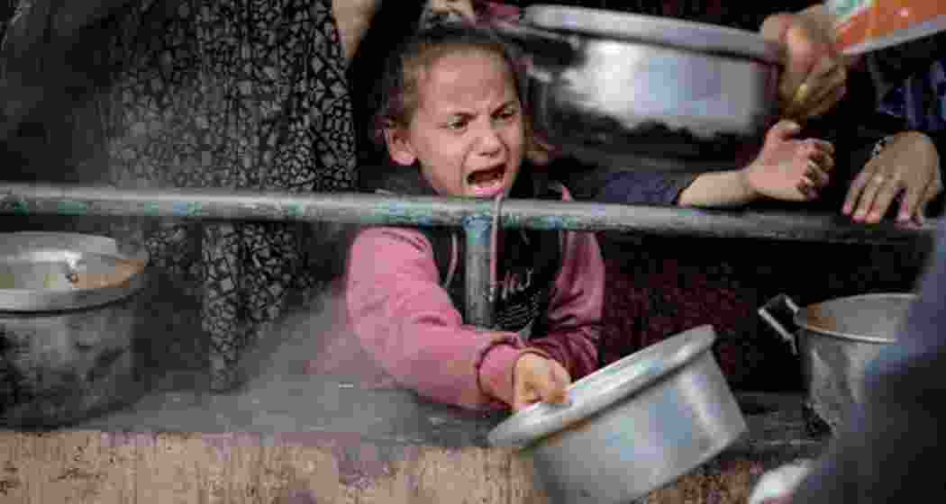 A child cries out for food at a Gaza distribution centre. A child cries out for food at a Gaza distribution centre.