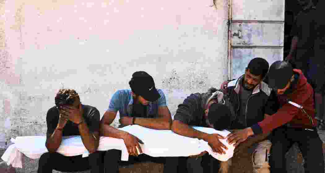 Palestinians mourn over the bodies of their relatives who were killed in an Israeli military strike on Gaza at Al-Shifa Hospital in Gaza City, Wednesday, June 4, 2025. Palestinians mourn over the bodies of their relatives who were killed in an Israeli military strike on Gaza at Al-Shifa Hospital in Gaza City, Wednesday, June 4, 2025.