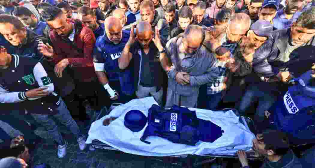 Colleagues and family members mourn during the funeral of Al Jazeera cameraman Samer Abudaqa in Khan Younis, Gaza. Colleagues and family members mourn during the funeral of Al Jazeera cameraman Samer Abudaqa in Khan Younis, Gaza.