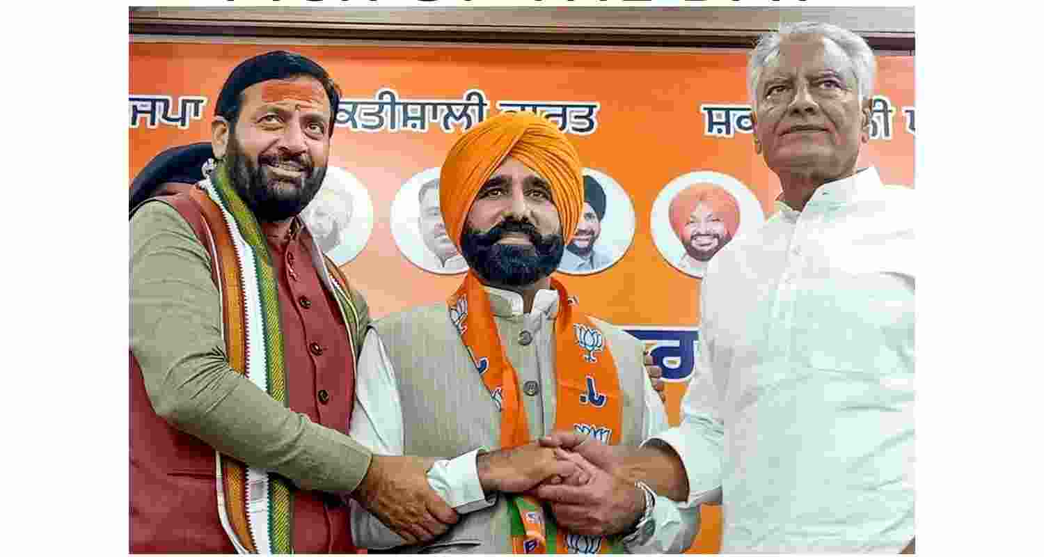 Haryana Chief Minister Nayab Singh Saini, left, BJP Punjab president Sunil Jakhar, right, with Punjab CM Bhagwant Mann's cousin Gyan Singh Mann during the latter's joining of the BJP. Haryana Chief Minister Nayab Singh Saini, left, BJP Punjab president Sunil Jakhar, right, with Punjab CM Bhagwant Mann's cousin Gyan Singh Mann during the latter's joining of the BJP.
