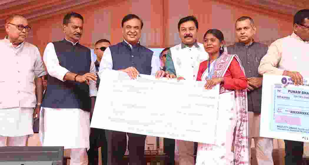 Assam CM Himanta Biswa Sarma distributes cheques to beneficiaries during a programme. Assam CM Himanta Biswa Sarma distributes cheques to beneficiaries during a programme.
