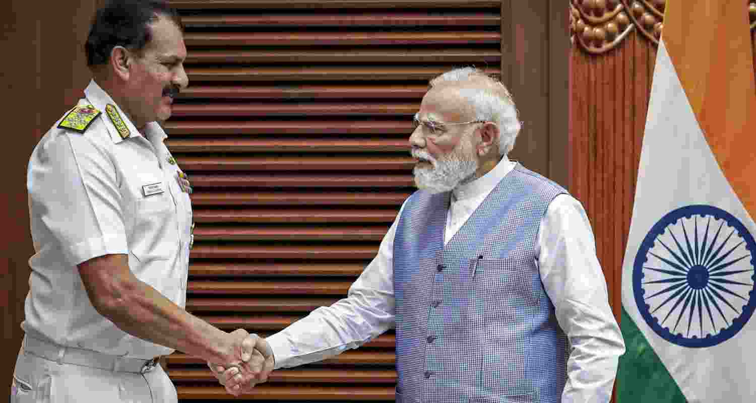 Prime Minister Narendra Modi, right, exchanges a handshake with outgoing Chief of the Naval Staff (CNS) Admiral Dinesh K Tripathi during a meeting. Prime Minister Narendra Modi, right, exchanges a handshake with outgoing Chief of the Naval Staff (CNS) Admiral Dinesh K Tripathi during a meeting.