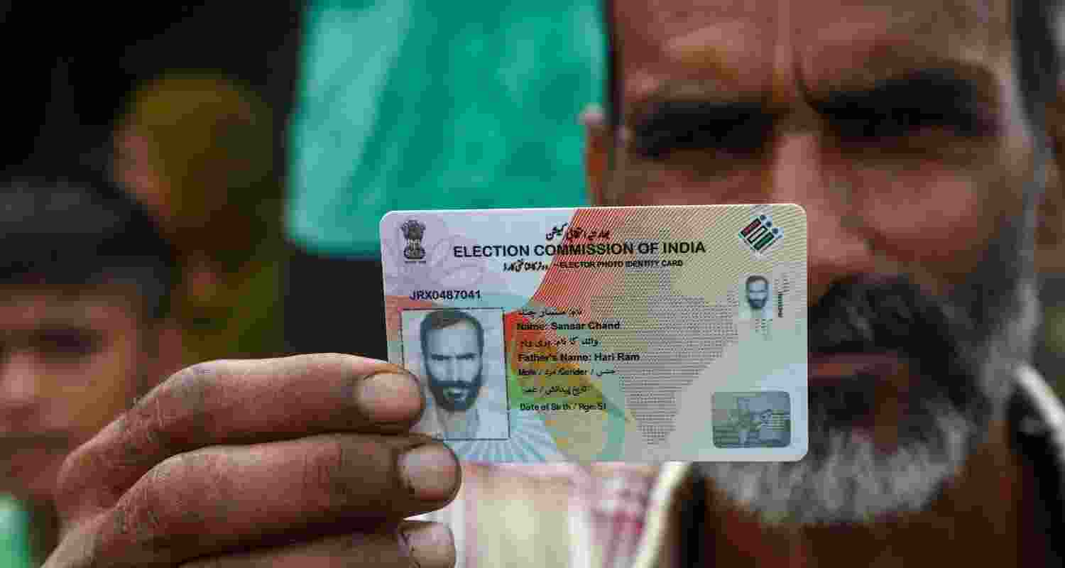 A voter shows his voter ID card during the Jammu and Kashmir polls. A voter shows his voter ID card during the Jammu and Kashmir polls.