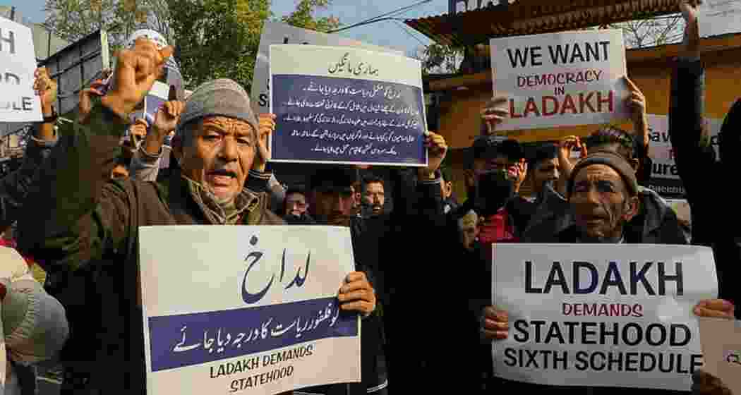 Residents from Ladakh hold placards demanding statehood and other democratic rights for their region during a protest in Leh. Residents from Ladakh hold placards demanding statehood and other democratic rights for their region during a protest in Leh.