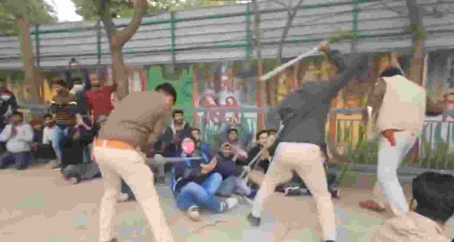 Police personnel lathi-charge protestors in Patna. Police personnel lathi-charge protestors in Patna.