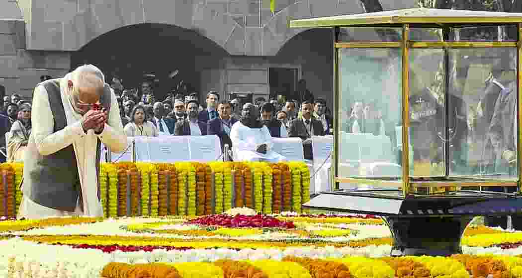 Prime Minister Narendra Modi pays homage to Mahatma Gandhi on his death anniversary at Rajghat, in New Delhi on Thursday. Prime Minister Narendra Modi pays homage to Mahatma Gandhi on his death anniversary at Rajghat, in New Delhi on Thursday.