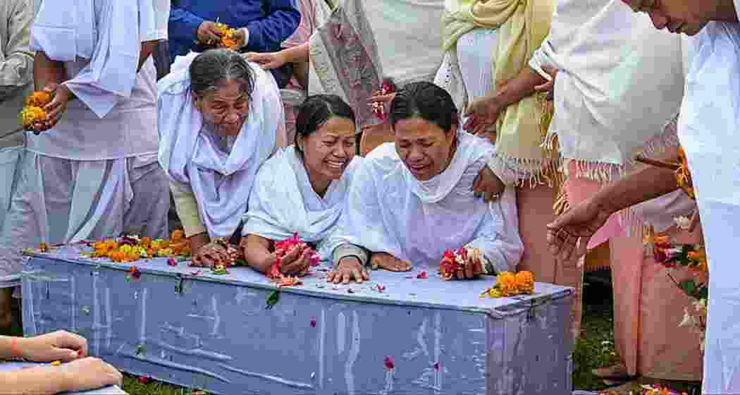 Family members perform the last rites of two children killed in a bomb attack in April in Bishnupur. PTI
Family members perform the last rites of two children killed in a bomb attack in April in Bishnupur. PTI