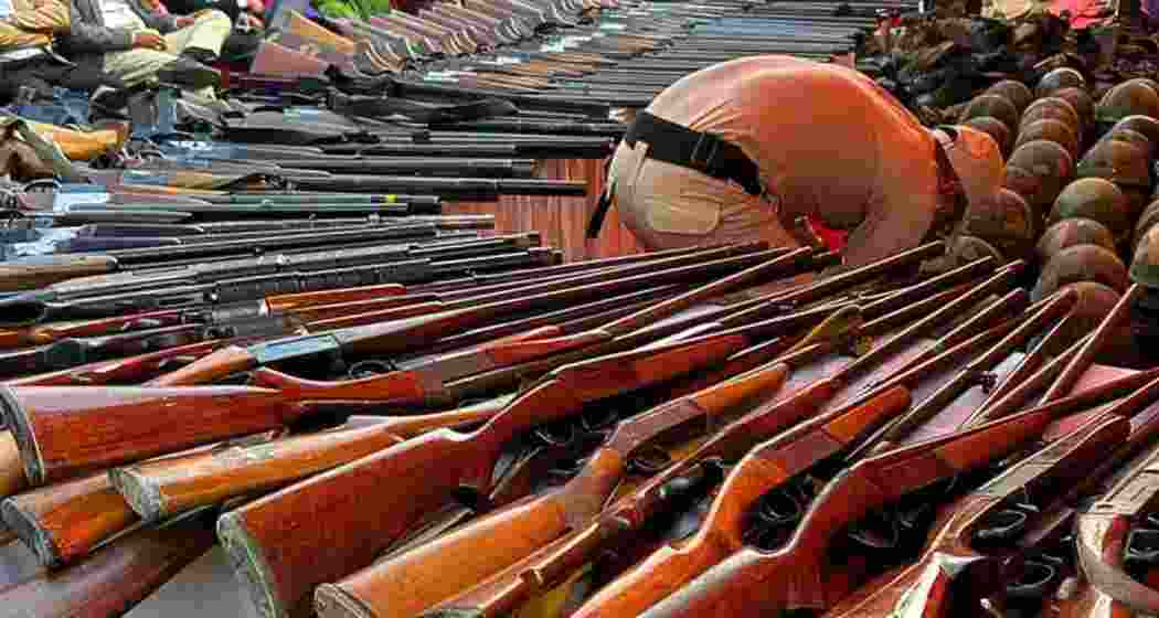 A security personnel inspects firearms surrendered as the deadline extension prompts fresh handovers, in Imphal, Manipur on Friday. A security personnel inspects firearms surrendered as the deadline extension prompts fresh handovers, in Imphal, Manipur on Friday.