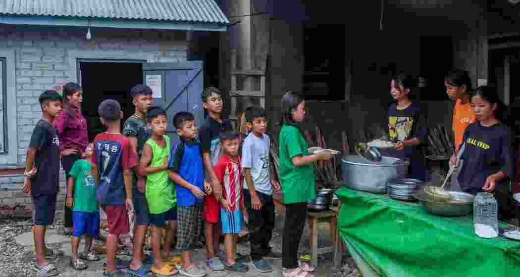 Children wait in queue to receive food at a relief camp in Manipur. Children wait in queue to receive food at a relief camp in Manipur.