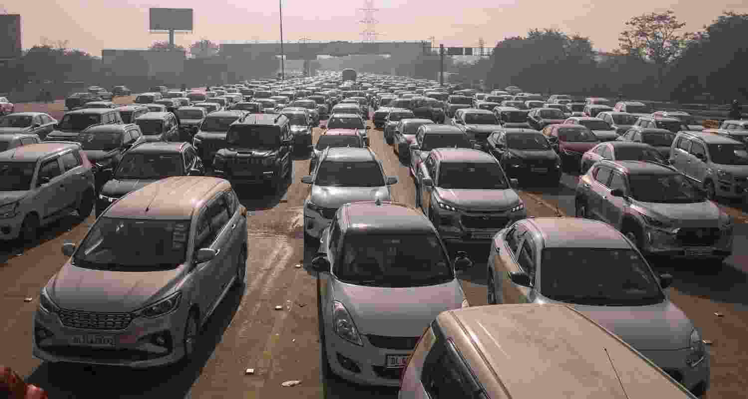 Vehicles stuck in a traffic jam on Delhi-Noida Direct Flyway after security was heightened in view of farmers' protest march towards the national capital, in Noida, Monday. Vehicles stuck in a traffic jam on Delhi-Noida Direct Flyway after security was heightened in view of farmers' protest march towards the national capital, in Noida, Monday.
