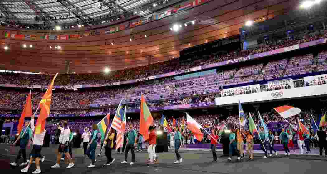 Athletes gather in the Stade de France during the closing ceremony, celebrating the conclusion of the Paris Olympics with flags, camaraderie, and a festive atmosphere. Athletes gather in the Stade de France during the closing ceremony, celebrating the conclusion of the Paris Olympics with flags, camaraderie, and a festive atmosphere.