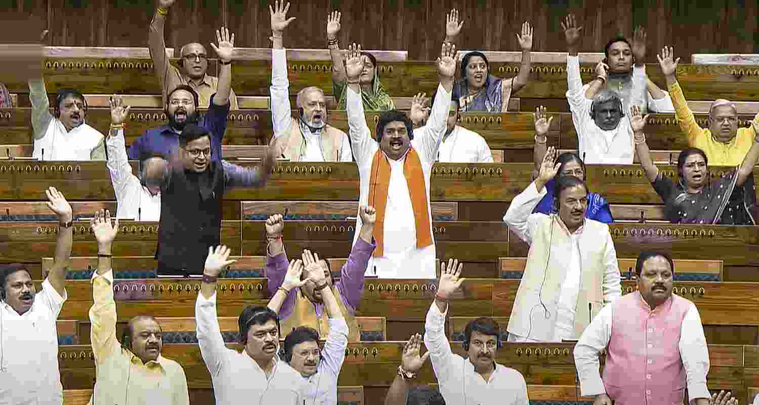 MPs react after Union Home Minister Amit Shah tabled three bills in the Lok Sabha during the Monsoon session of Parliament, in New Delhi, Wednesday. MPs react after Union Home Minister Amit Shah tabled three bills in the Lok Sabha during the Monsoon session of Parliament, in New Delhi, Wednesday.