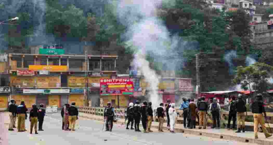 Police personnel stand on a bridge as they stop the protesters of the Awami Action Committee during a protest following a shutter-down strike in Muzaffarabad, the capital of Pakistan Occupied Jammu and Kashmir (PoJK). Police personnel stand on a bridge as they stop the protesters of the Awami Action Committee during a protest following a shutter-down strike in Muzaffarabad, the capital of Pakistan Occupied Jammu and Kashmir (PoJK).