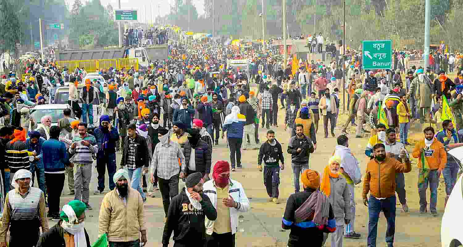 Farmers move away after police fired teargas shell to disperse them during their 'Delhi Chalo' march at Punjab-Haryana Shambhu border, near Patiala, Tuesday. Farmers move away after police fired teargas shell to disperse them during their 'Delhi Chalo' march at Punjab-Haryana Shambhu border, near Patiala, Tuesday.