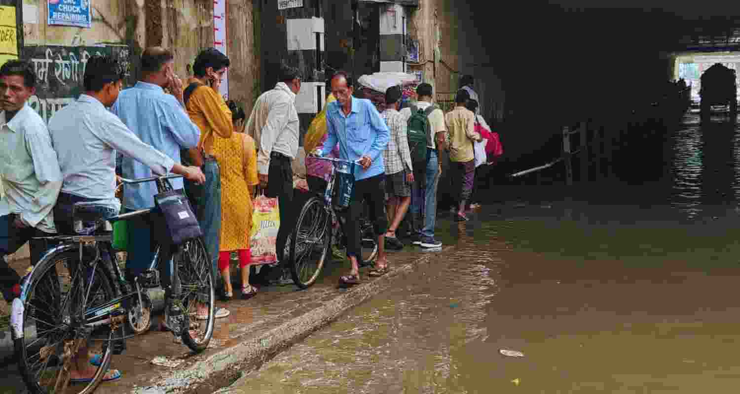 Commuters wade through a waterlogged Old Faridabad underpass after heavy rain, in Faridabad, Thursday, August 1. Commuters wade through a waterlogged Old Faridabad underpass after heavy rain, in Faridabad, Thursday, August 1.
