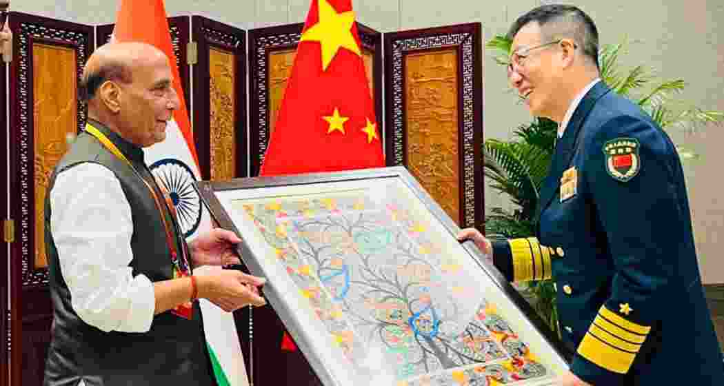 Defence Minister Rajnath Singh presents a Madhubani painting from Bihar to Chinese Defence Minister Admiral Don Jun during a meeting in Qingdao on the sidelines of the SCO conclave on Friday. Defence Minister Rajnath Singh presents a Madhubani painting from Bihar to Chinese Defence Minister Admiral Don Jun during a meeting in Qingdao on the sidelines of the SCO conclave on Friday.